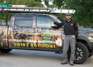Owner, Kenneth Arbuckle leaning on AAAC Wildlife truck
